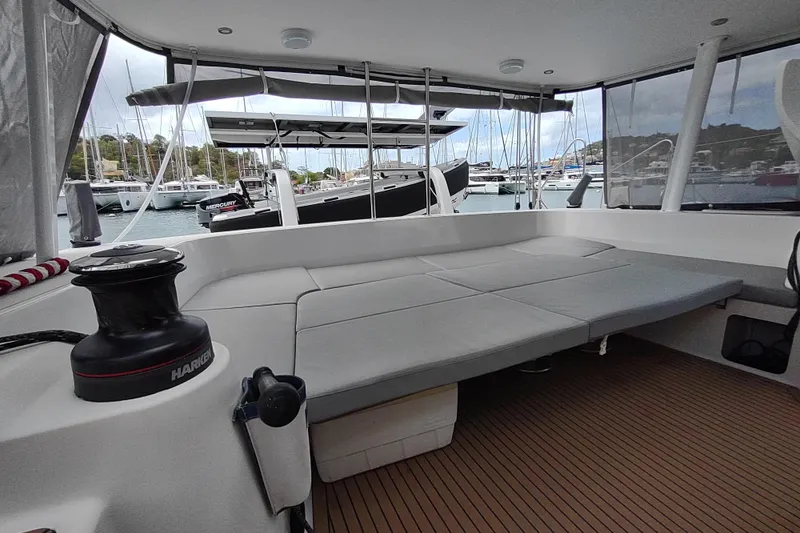 Slide: The Image of 2020 Outremer 51 catamaran interior with spacious seating and marina view. - 45