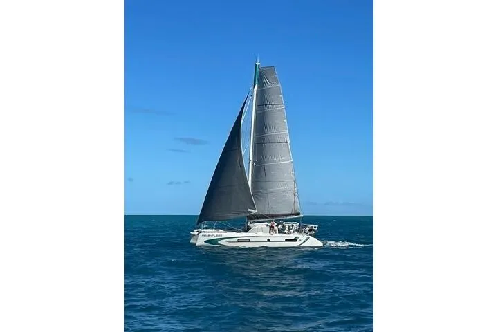Slide: The Image of 2020 Outremer 51 sailing catamaran on open sea under clear blue sky. - 5