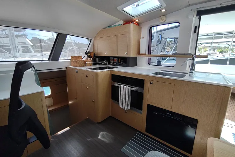 Slide: The Image of Modern kitchen interior of 2020 Outremer 51 yacht with sleek design and ample natural light. - 51