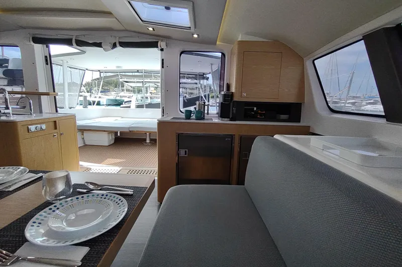 Slide: The Image of Interior of 2020 Outremer 51 yacht, featuring dining area and modern kitchen. - 52