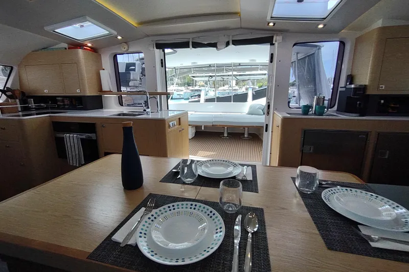 Slide: The Image of Interior of 2020 Outremer 51 yacht, featuring dining area and modern kitchen. - 54