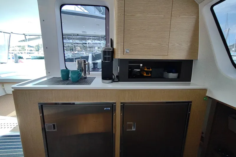 Slide: The Image of Interior of 2020 Outremer 51 yacht with kitchenette, Keurig coffee maker, and modern cabinetry. - 55