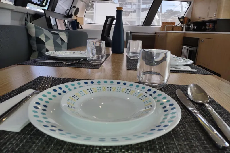 Slide: The Image of Dining area inside 2020 Outremer 51 yacht with elegant table setting. - 56