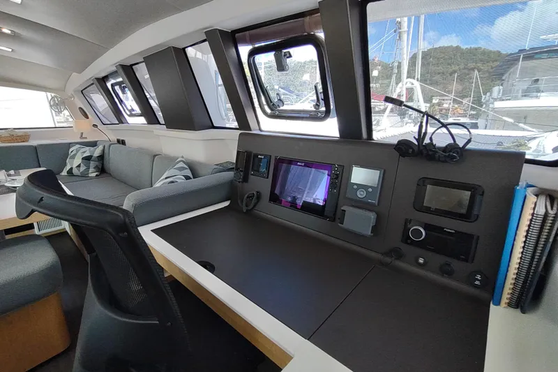 Slide: The Image of Interior of 2020 Outremer 51 yacht with navigation station and seating area. - 59
