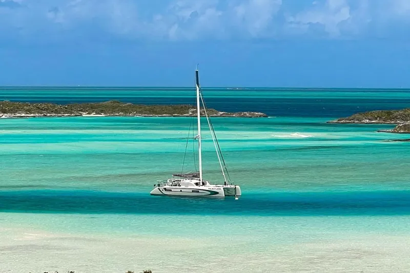 Slide: The Image of Outremer 51 catamaran sailing in turquoise waters, 2020 model, serene tropical seascape. - 6