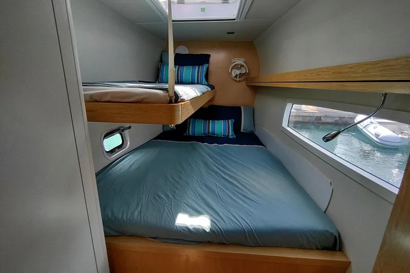 Slide: The Image of Cozy cabin interior of 2020 Outremer 51 catamaran with bunk beds and window view. - 67