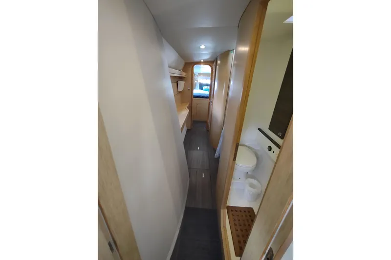 Slide: The Image of Interior of 2020 Outremer 51 yacht, featuring a narrow hallway and modern bathroom. - 68