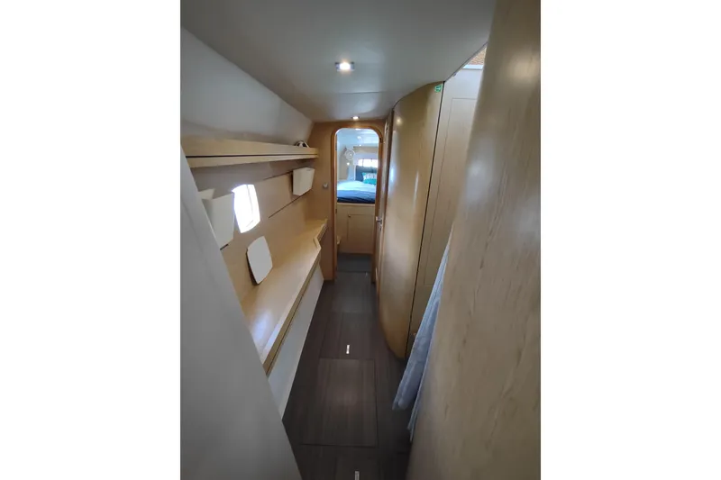 Slide: The Image of Interior hallway of 2020 Outremer 51 yacht, featuring modern wood finishes and ambient lighting. - 69