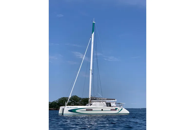 Slide: The Image of 2020 Outremer 51 catamaran sailing on calm blue waters under clear skies. - 7