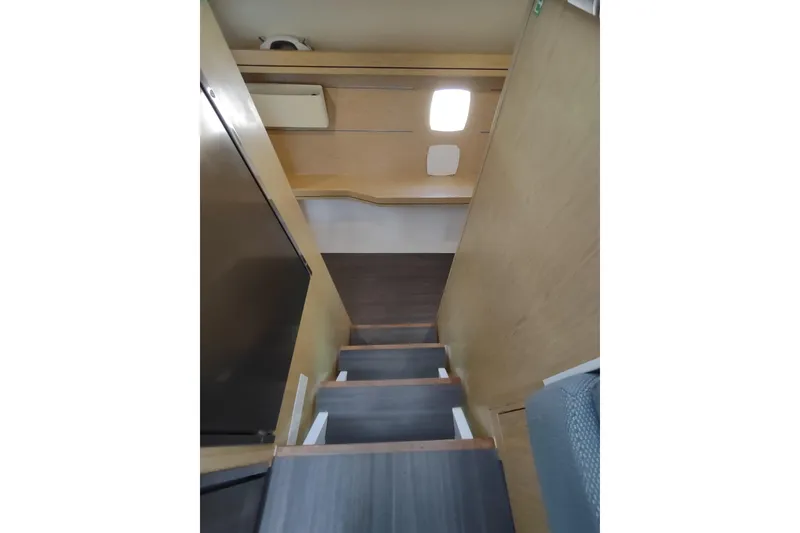Slide: The Image of Interior stairs of 2020 Outremer 51 catamaran, featuring wooden steps and modern design. - 74