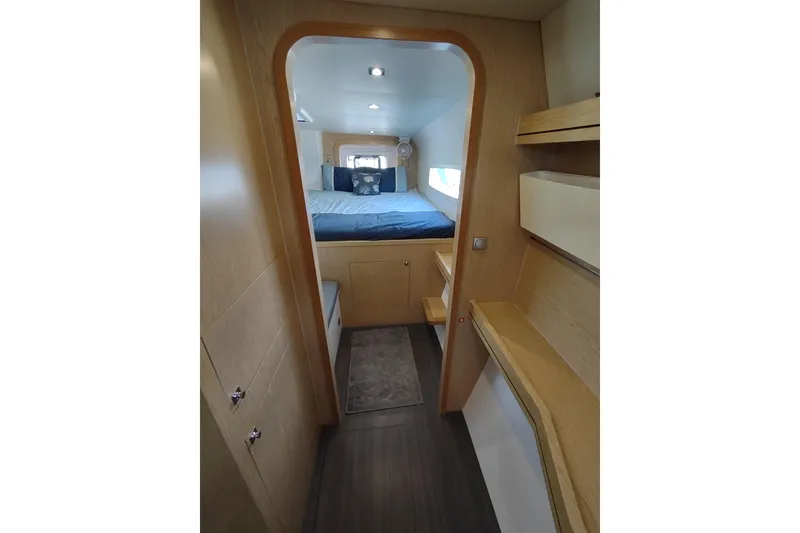Slide: The Image of 2020 Outremer 51 yacht interior cabin with bed, wooden finish, and modern design. - 75