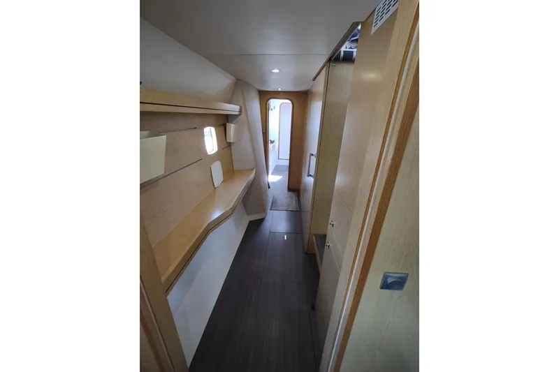 Slide: The Image of Interior hallway of 2020 Outremer 51 yacht, featuring sleek wooden design and modern lighting. - 79