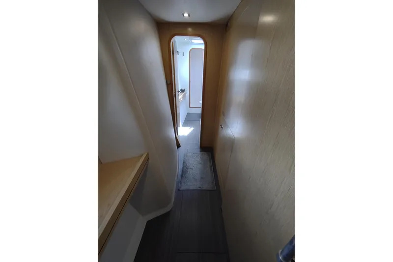Slide: The Image of Narrow hallway inside 2020 Outremer 51 yacht, featuring wooden paneling and modern design. - 80