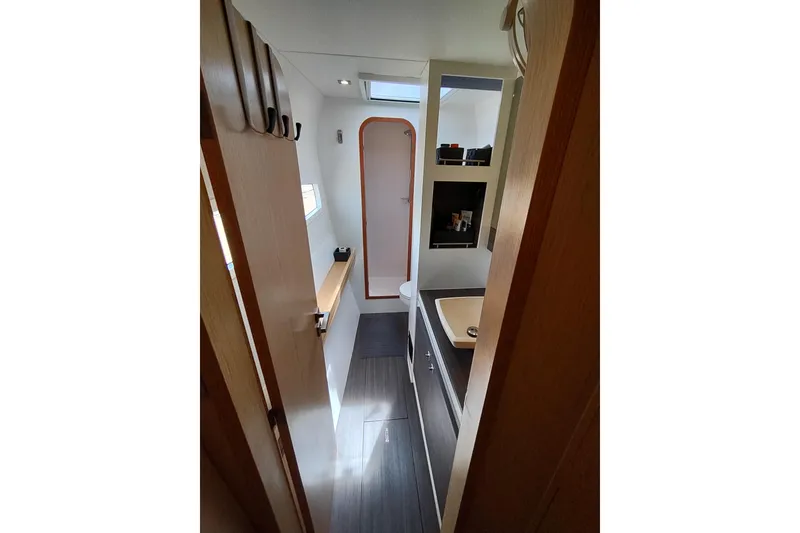 Slide: The Image of Interior of 2020 Outremer 51 yacht, featuring modern bathroom with sink and storage. - 81