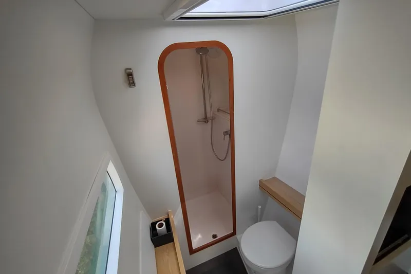 Slide: The Image of 2020 Outremer 51 yacht bathroom with shower, toilet, and skylight. - 83