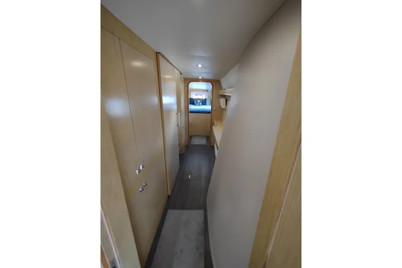 Slide: The Image of Interior hallway of 2020 Outremer 51 yacht, featuring sleek wooden cabinetry and modern design. - 89