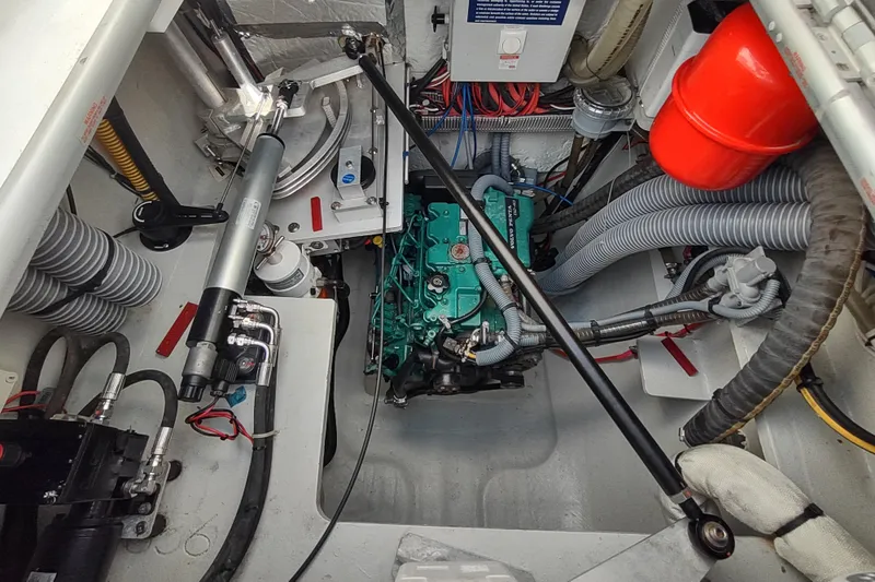 Slide: The Image of Engine compartment of 2020 Outremer 51 catamaran, showcasing mechanical components and wiring. - 90