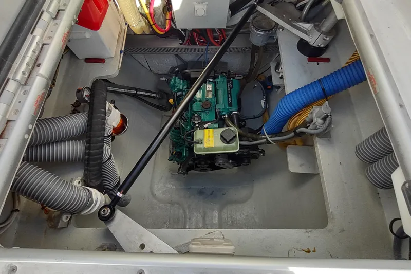 Slide: The Image of Engine compartment of a 2020 Outremer 51 catamaran, showcasing mechanical components and hoses. - 91