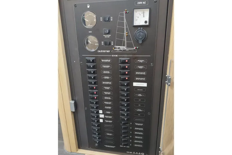 Slide: The Image of Electrical control panel on a 2020 Outremer 51 catamaran, featuring switches and gauges. - 93