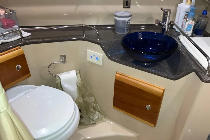 Slide: The Image of 2017 Cutwater C-30 Sedan bathroom with blue glass sink and modern fixtures. - 70