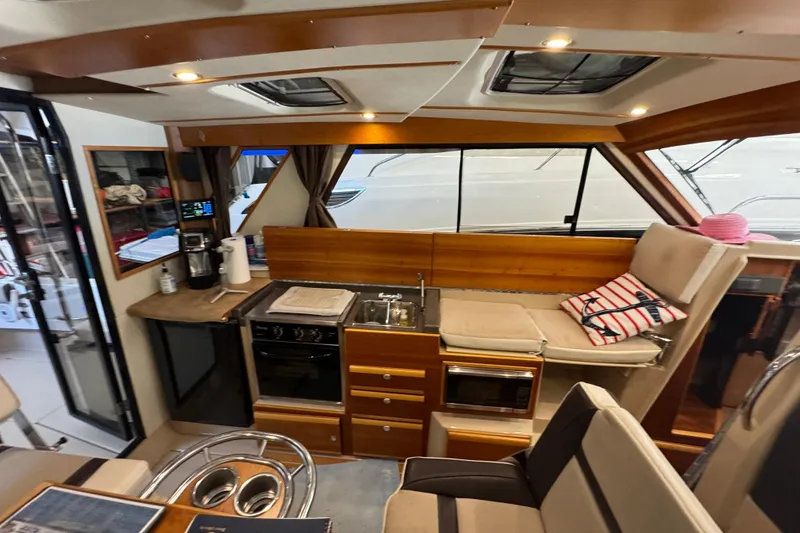 Slide: The Image of Interior of 2017 Cutwater C-30 Sedan yacht with kitchen and seating area. - 32
