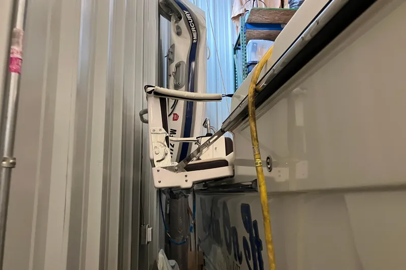 Slide: The Image of 2017 Cutwater C-30 Sedan boat stored indoors with Mercury outboard motor. - 112