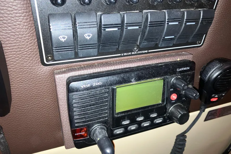 Slide: The Image of 2017 Cutwater C-30 Sedan dashboard with Garmin VHF 200 radio and control panel. - 65
