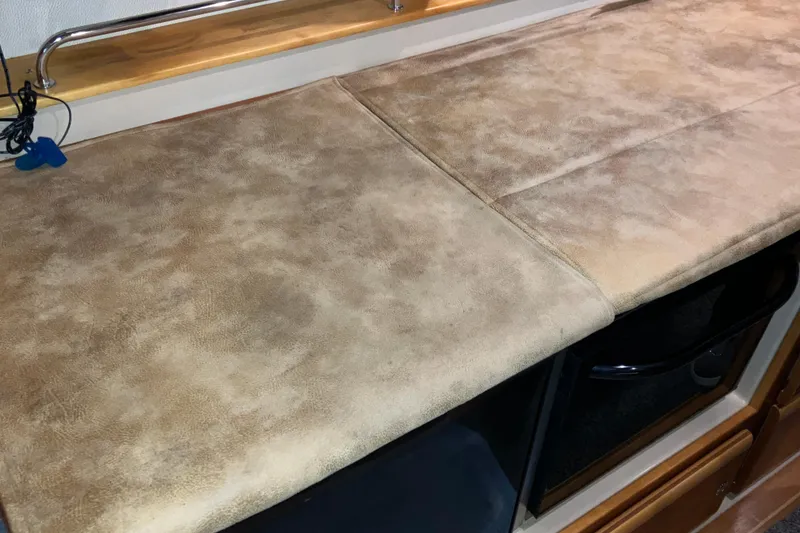 Slide: The Image of 2017 Cutwater C-30 Sedan interior with beige countertop and wooden accents. - 38