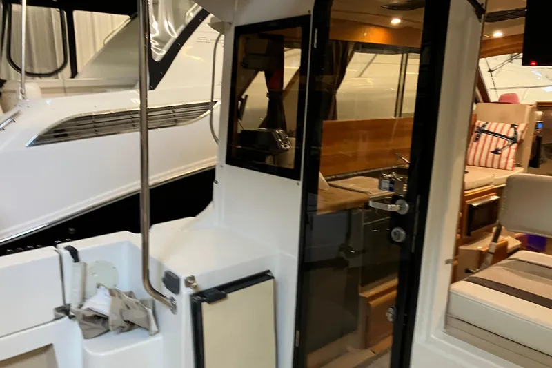 Slide: The Image of 2017 Cutwater C-30 Sedan interior view with seating and kitchen area. - 22