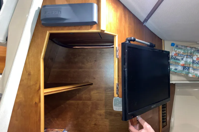 Slide: The Image of Interior of 2017 Cutwater C-30 Sedan with mounted TV and wooden cabinetry. - 67