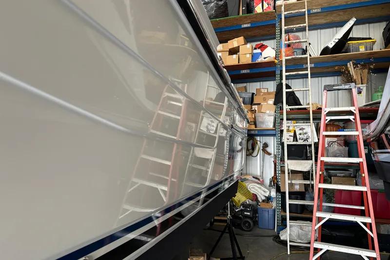Slide: The Image of 2017 Cutwater C-30 Sedan in storage, surrounded by shelves and ladders. - 6