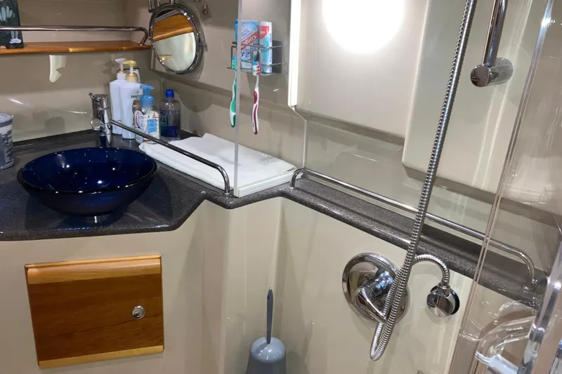 Slide: The Image of 2017 Cutwater C-30 Sedan bathroom with modern sink, toiletries, and showerhead. - 69