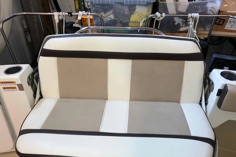 Slide: The Image of 2017 Cutwater C-30 Sedan boat seat with beige and white upholstery, surrounded by storage items. - 19