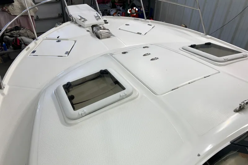 Slide: The Image of 2017 Cutwater C-30 Sedan boat deck with hatches and railing in a storage area. - 95