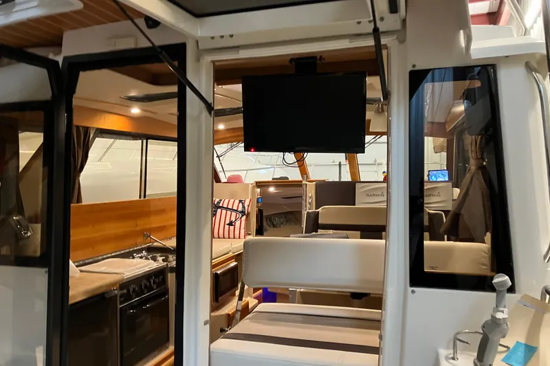 Slide: The Image of Interior view of 2017 Cutwater C-30 Sedan, featuring kitchen and seating area. - 20