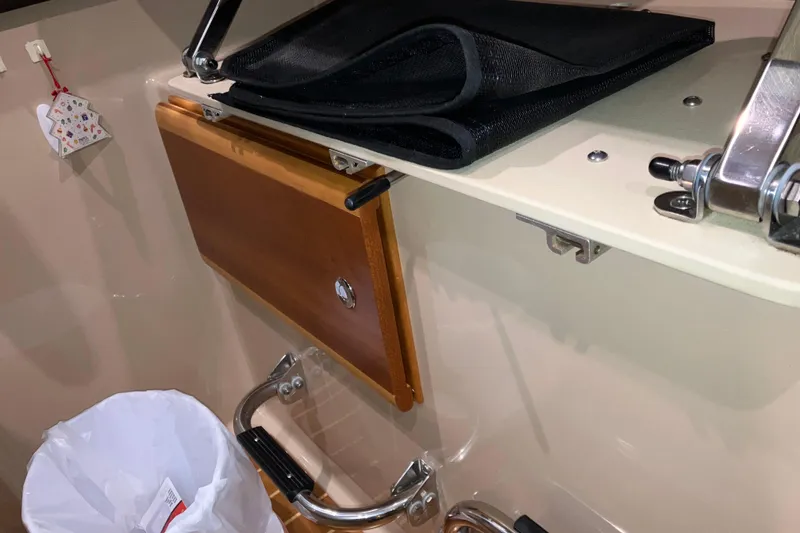 Slide: The Image of 2017 Cutwater C-30 Sedan interior with wooden panel and metal fixtures. - 53