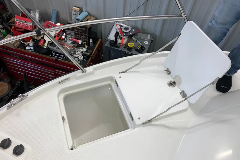 Slide: The Image of 2017 Cutwater C-30 Sedan boat deck with open hatch and visible storage area. - 97