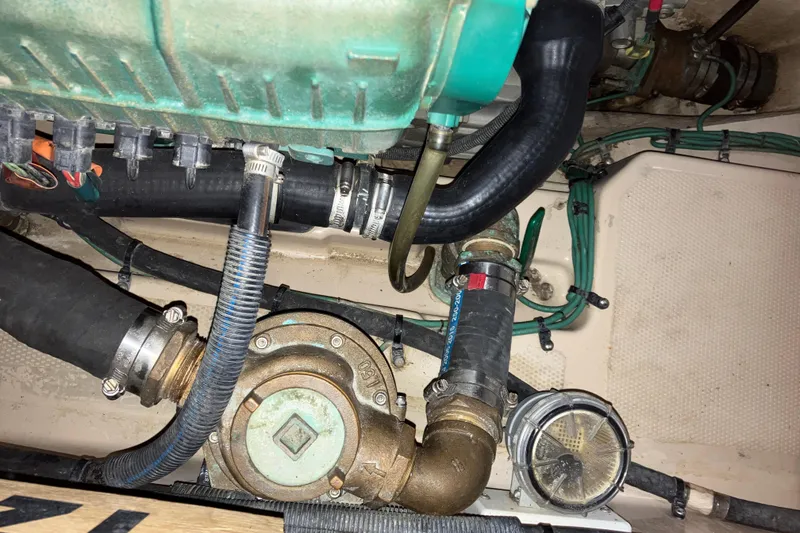 Slide: The Image of Engine compartment of a 2017 Cutwater C-30 Sedan boat, showing hoses and mechanical components. - 84