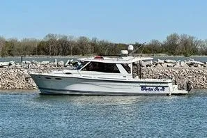 Slide: The Image of 2017 Cutwater C-30 Sedan boat on calm water near rocky shoreline. - 116