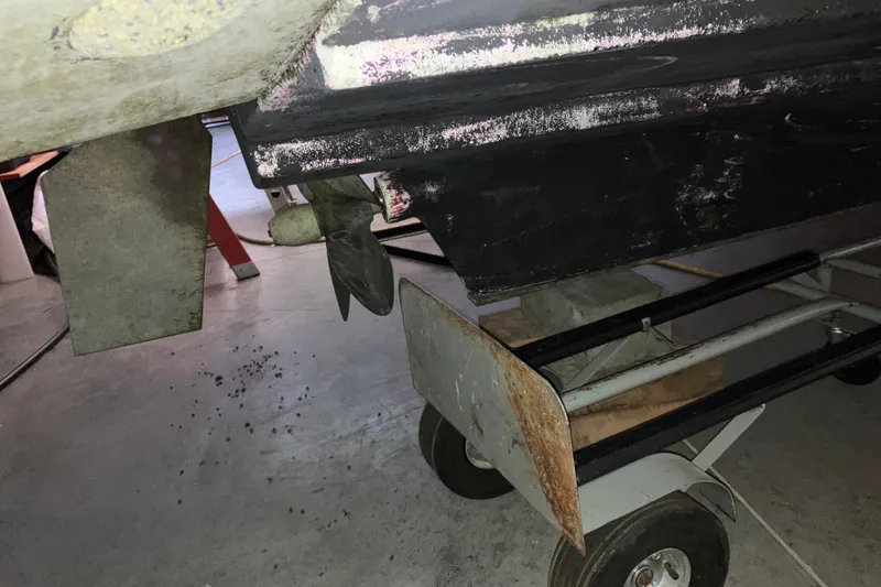 Slide: The Image of 2017 Cutwater C-30 Sedan boat propeller and rudder on a trailer in a garage. - 115