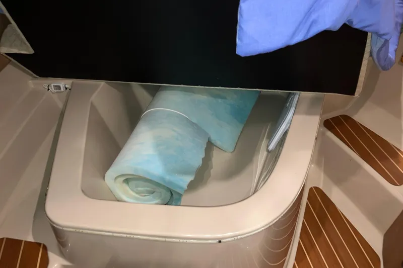Slide: The Image of Storage compartment in 2017 Cutwater C-30 Sedan with rolled blue mat. - 79