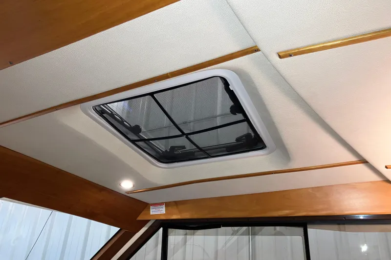 Slide: The Image of 2017 Cutwater C-30 Sedan interior ceiling with skylight and wooden accents. - 82