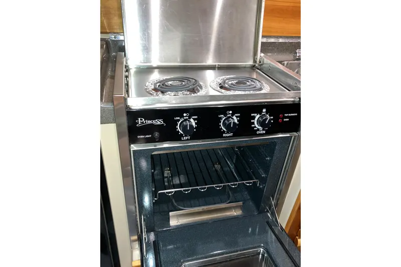 Slide: The Image of Stove and oven inside a 2017 Cutwater C-30 Sedan boat kitchen. - 41