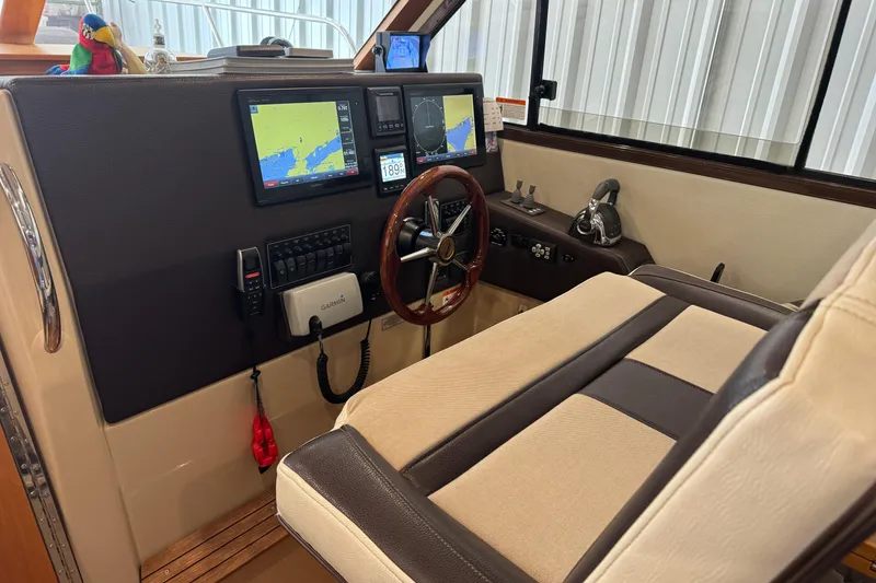 Slide: The Image of Interior of a 2017 Cutwater C-30 Sedan boat with navigation equipment and steering wheel. - 47