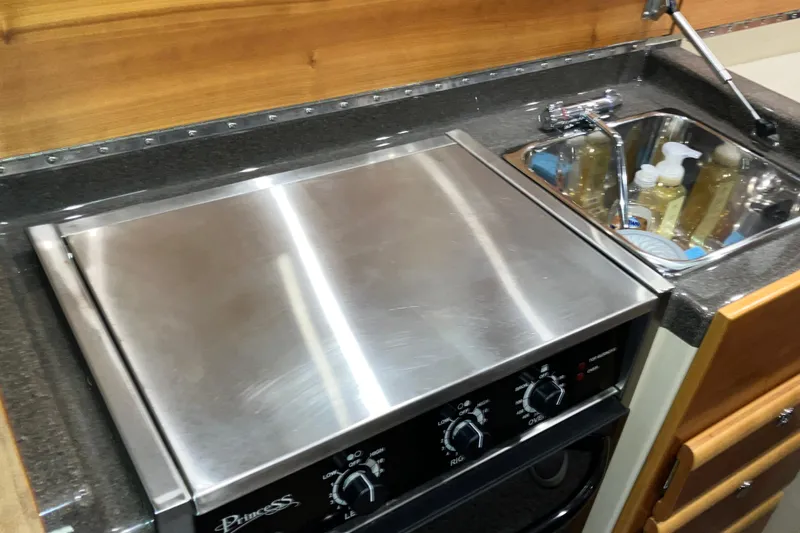 Slide: The Image of 2017 Cutwater C-30 Sedan kitchen with stainless steel stove and sink. - 40