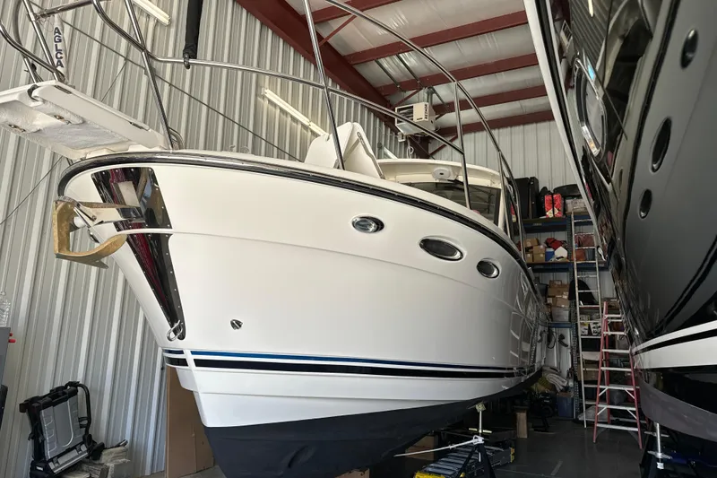 Slide: The Image of 2017 Cutwater C-30 Sedan boat stored indoors, showcasing sleek design and modern features. - 2