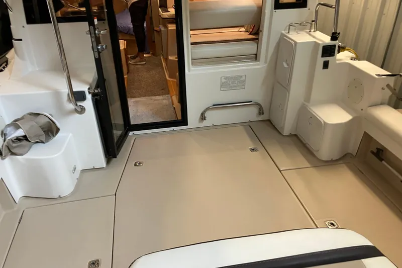 Slide: The Image of 2017 Cutwater C-30 Sedan interior with open door, showcasing seating and storage areas. - 11