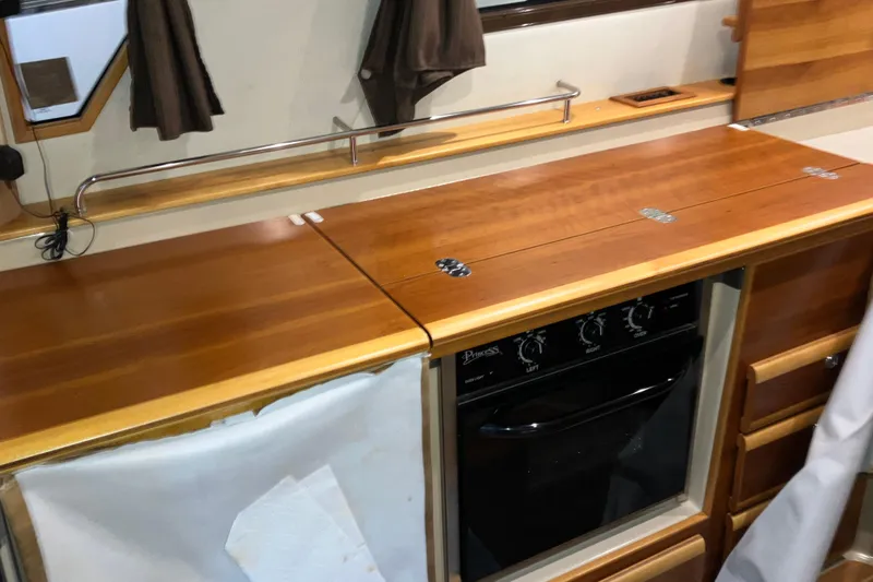 Slide: The Image of 2017 Cutwater C-30 Sedan interior kitchen with wooden countertops and built-in oven. - 37