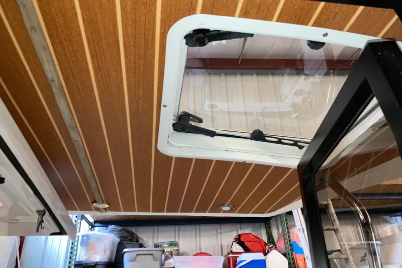 Slide: The Image of 2017 Cutwater C-30 Sedan interior with wood paneling and storage area. - 66