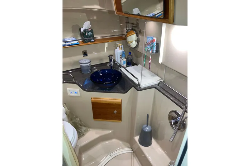 Slide: The Image of 2017 Cutwater C-30 Sedan bathroom with modern sink, mirror, and shower amenities. - 71